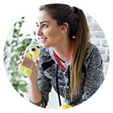 image of a woman drinking fruit water