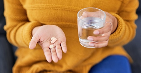 woman taking pills