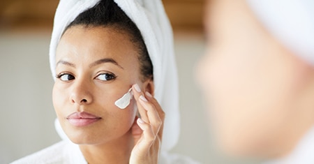 Woman smearing facial product