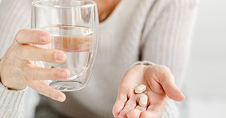 woman holding vitamins